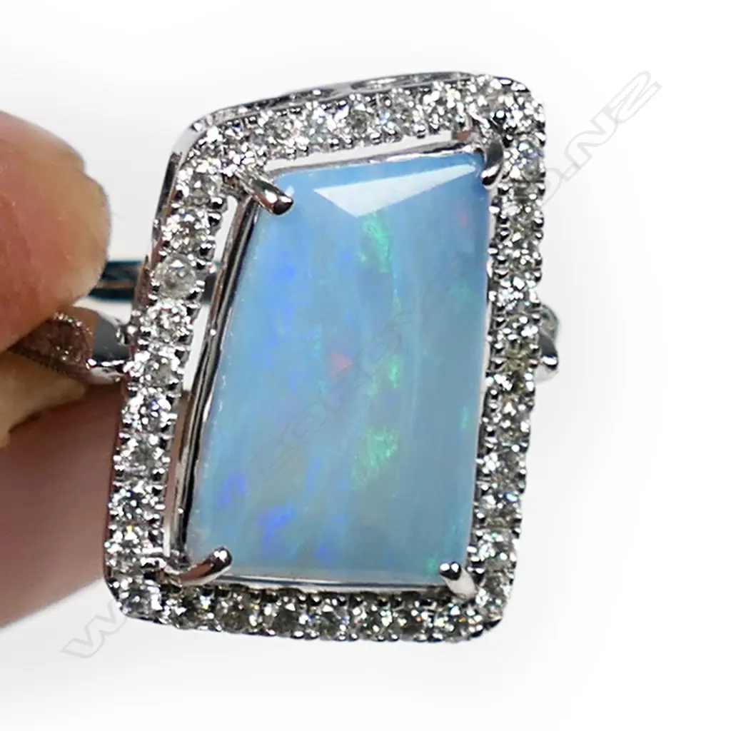 A 14ct white gold, opal and diamond halo ring, Image 1++