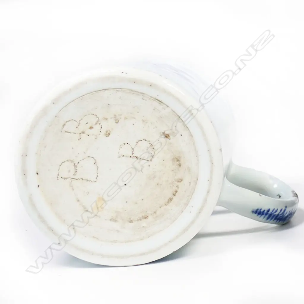 An 18th/19thC Chinese export mug blue and white floral decoration glaze fritting to handle. H.123mm.The handle professionally restored. Image 1++