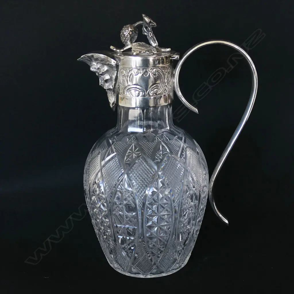 A Victorian silver plate and crystal claret jug elaborate cut decoration to the body, the spout in the form of the head of Bacchus with grape vine finial to lid, engraved collar and looping ear form handle. H.240mm. Image 1++