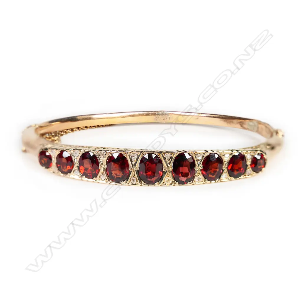 An Edwardian 9ct rose gold garnet and diamond hinged bangle, Image 1++