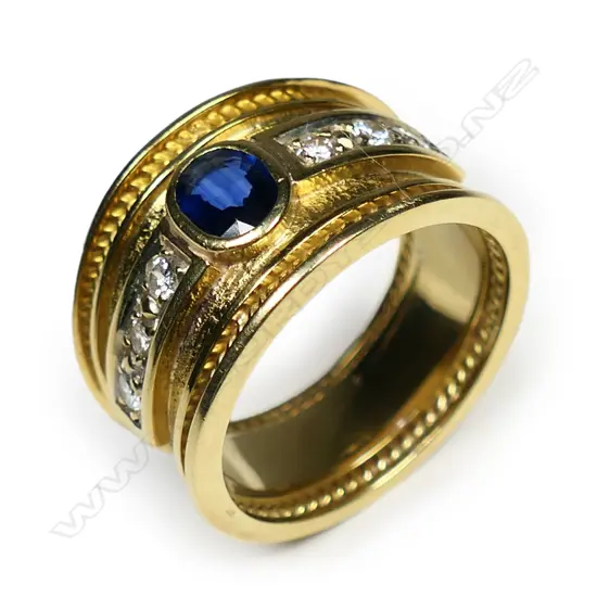 A heavy 18ct yellow gold sapphire and diamond wide band ring,