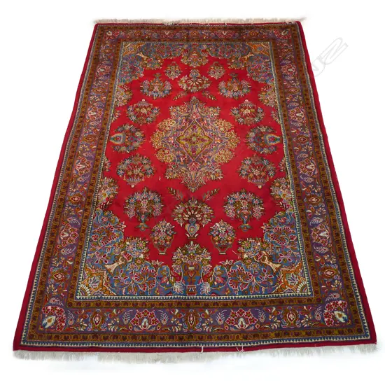 A large Golypayegan Isfahan carpet. The central field decorated with a large floral medallion surrounded by multiple floral basket motifs to the field and quadrants. Framed by traditional border guards. 3000 x 2000mm.