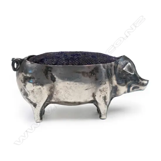 An Edwardian silver pig pin cushion,