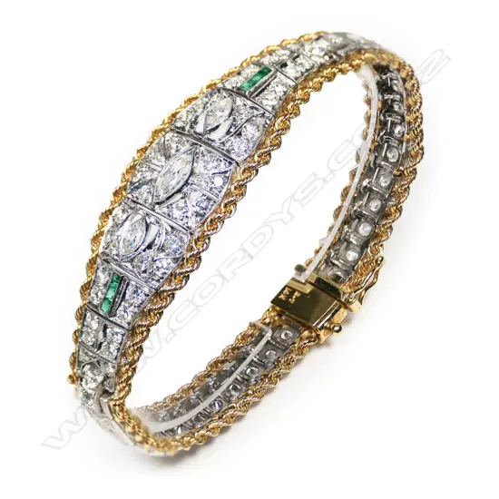 An impressive vintage platinum and 14ct yellow gold diamond and emerald bracelet,