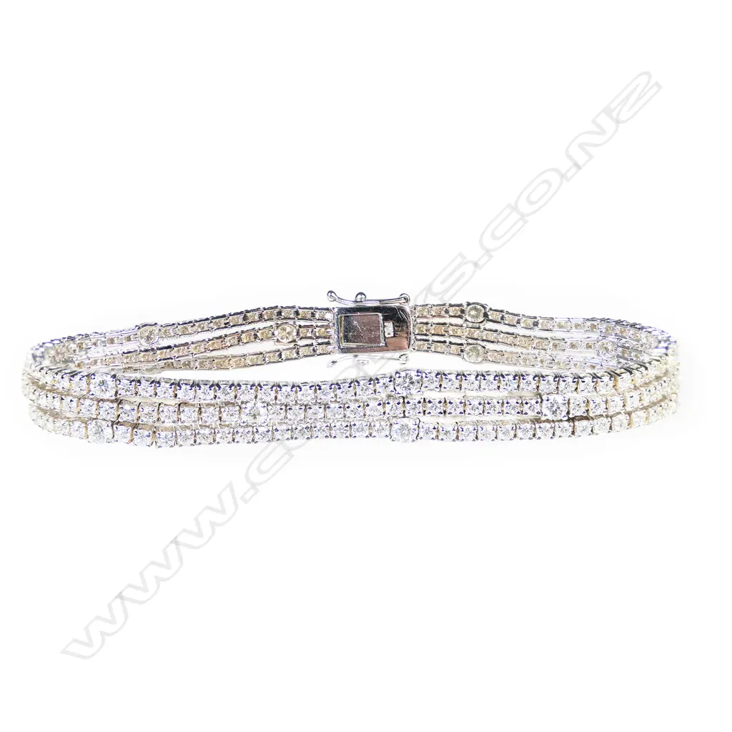 An 18ct white gold and diamond triple line bracelet, Image 1++