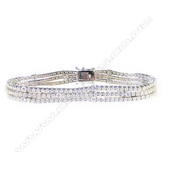 An 18ct white gold and diamond triple line bracelet,