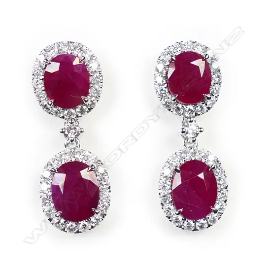 A pair of 14ct white gold ruby and diamond double drop earrings,
