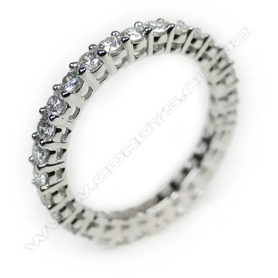A platinum and diamond eternity band ring,