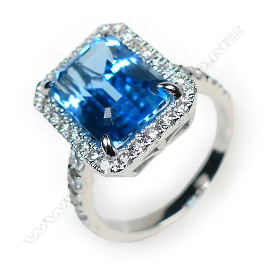 An 18ct white gold blue topaz and diamond cluster ring,