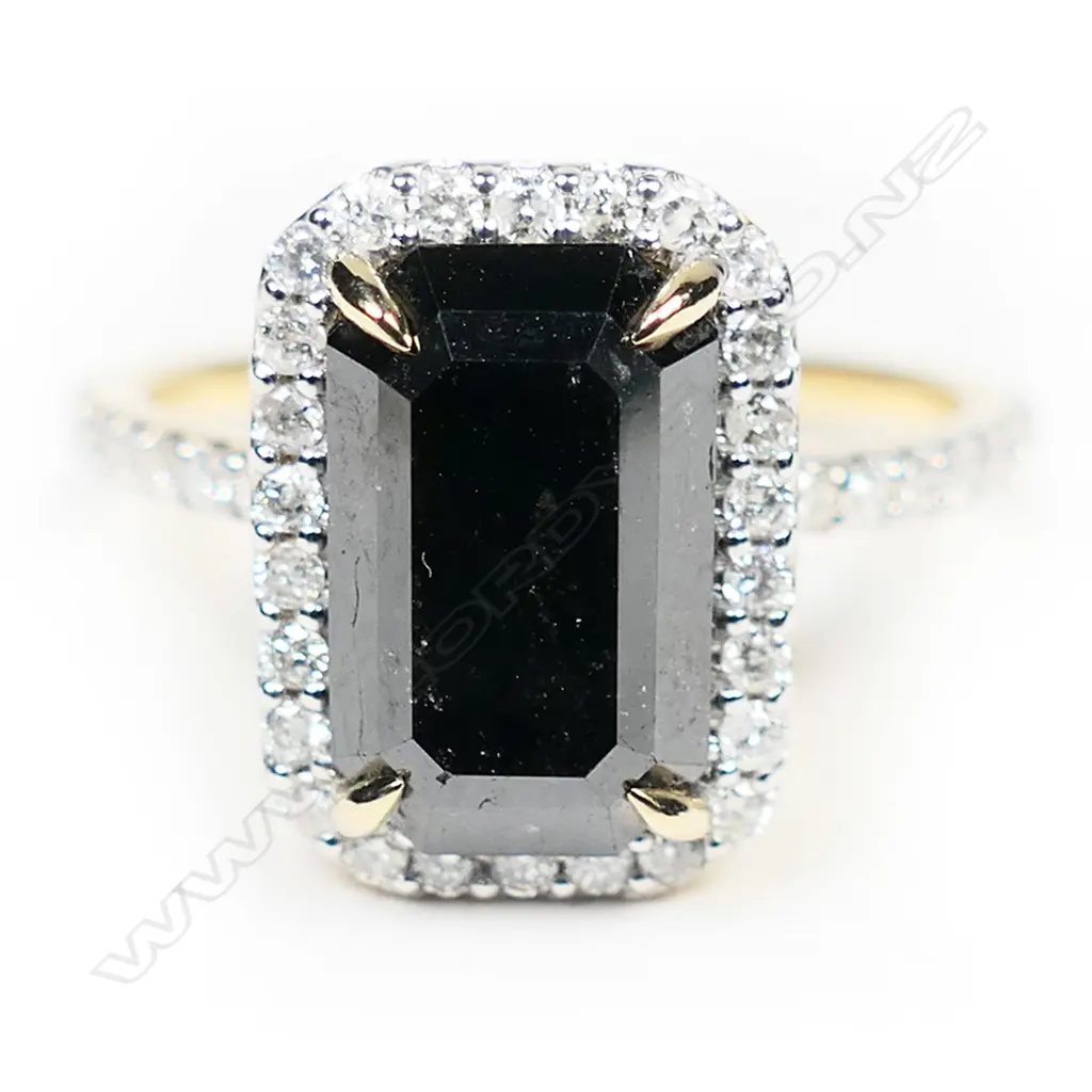 A 14ct gold and black diamond halo ring Image 1++
