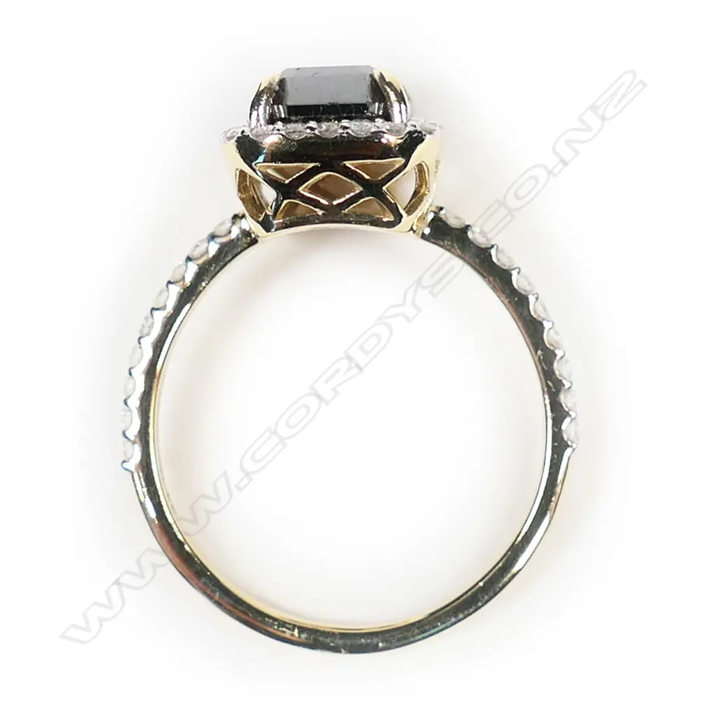 A 14ct gold and black diamond halo ring Image 1++