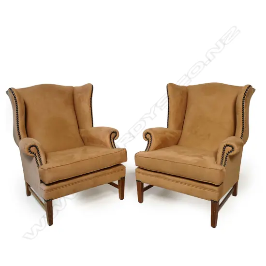 A pair of wingback armchairs,
