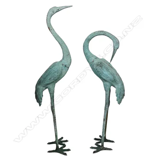 A pair of bronze storks,