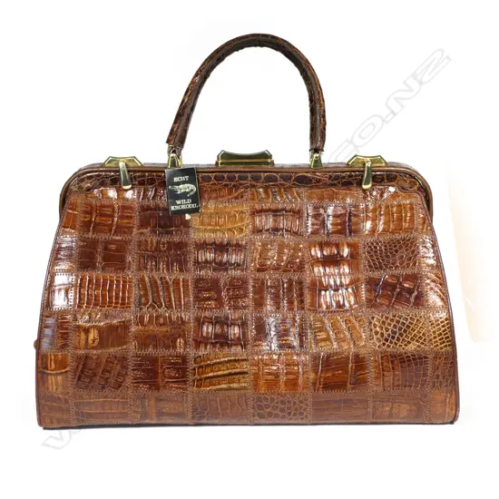 A substantial vintage crocodile travelling bag,