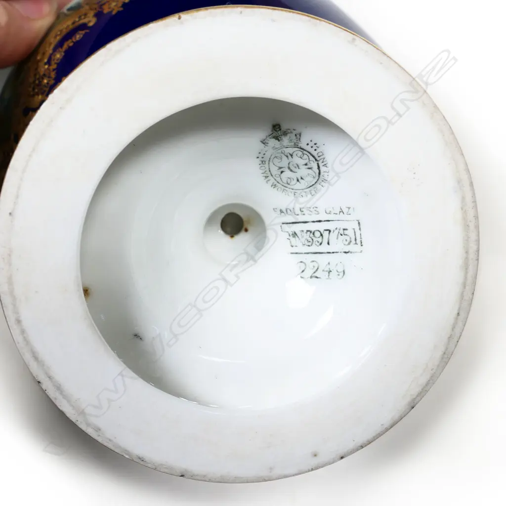 A hand-painted Royal Worcester vase by Harry Davis. The vignette of a lake with a castle in the foreground. Swollen shape with flared opening and gilt highlights. With registration number date for 1902. H.230mm. Image 1++