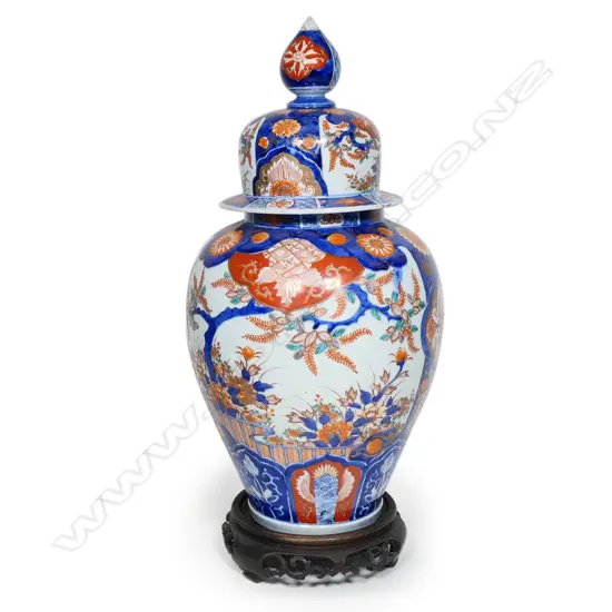 A large Japanese Imari lidded urn on wooden stand,