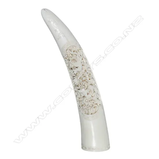 A carved ivory tusk,