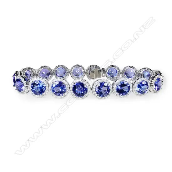 A 14ct white gold tanzanite and diamond halo bracelet,