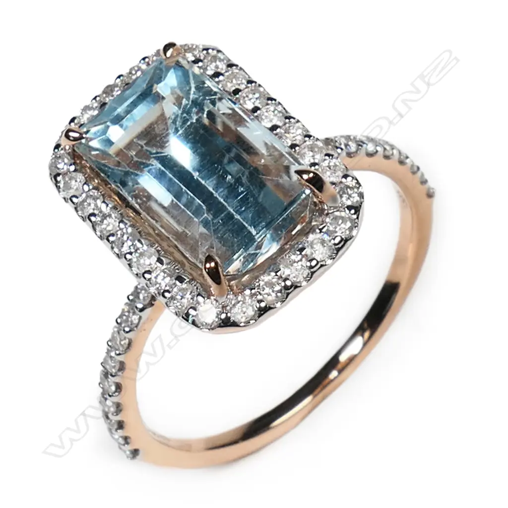 A 14ct rose gold aquamarine and diamond halo ring, Image 1++