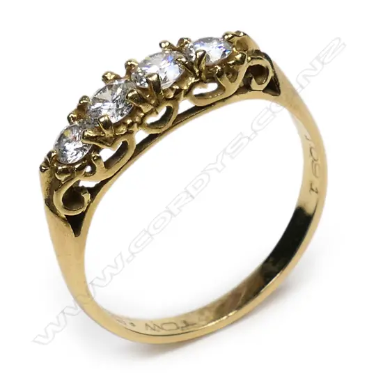 An estate 18ct gold and four stone diamond ring,