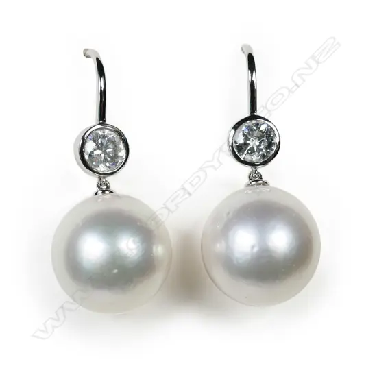 A pair of 14ct white gold pearl and diamond earrings,