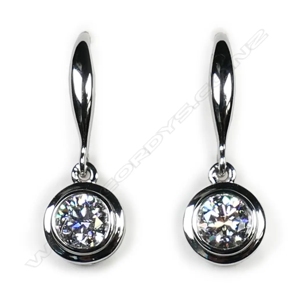 A pair of 18ct white gold and diamond solitaire earrings, Image 1++