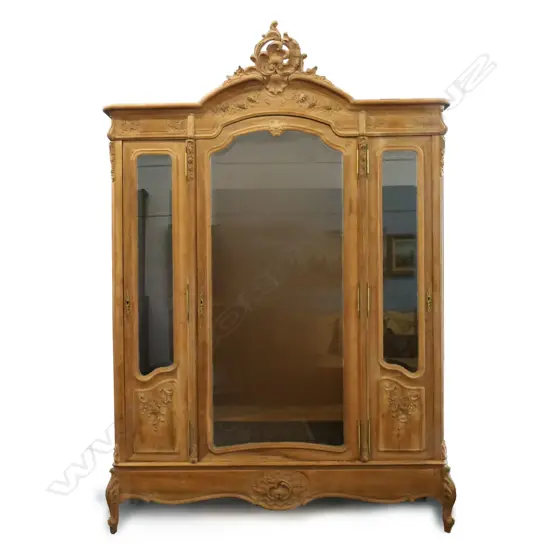 An early 20thC antique style French walnut armoire,