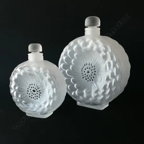 A graduated pair of Lalique glass Dahlia perfume bottles,