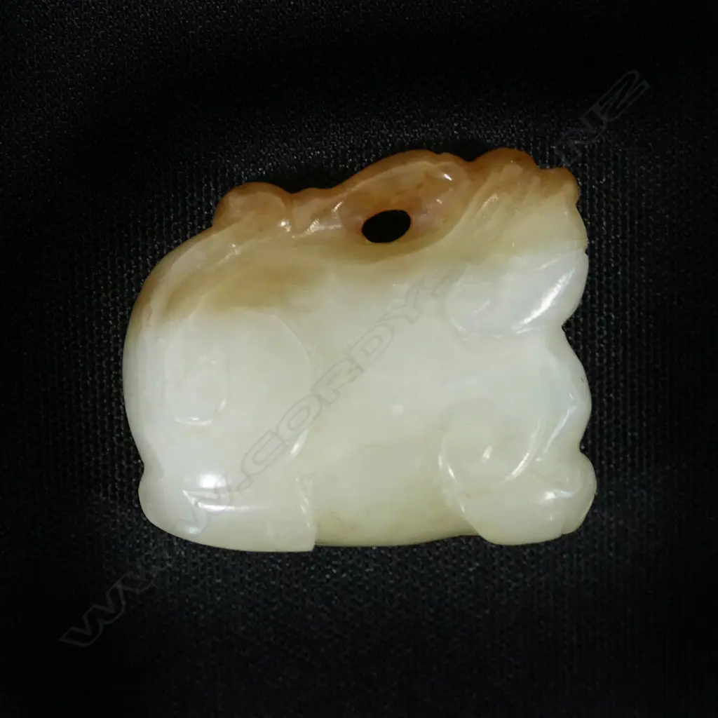 A Chinese carved pale jade pendant of a mythical beast, Image 1++