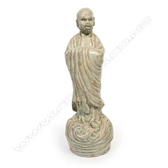 An old Chinese celadon glazed deity figure,