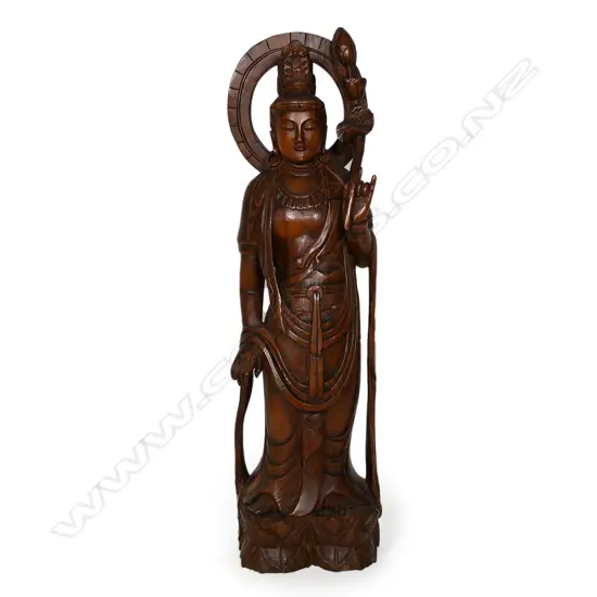 An old Oriental carved wood figure of the serene goddess Quan Yin,