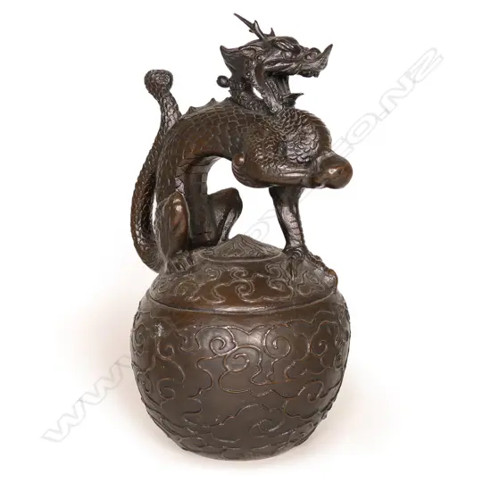 An old oriental heavy bronze sculpture of an imperial three claw dragon,