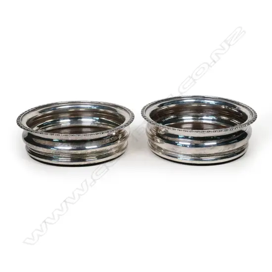 A pair of late Victorian silver plate wine coasters,