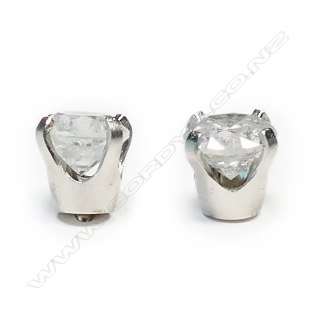 A pair of 14ct white gold and diamond stud earrings, Image 1++