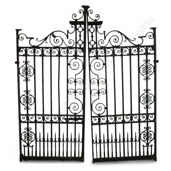 A pair of old fancy cast iron driveway entrance gates,