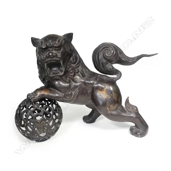 An old Japanese bronze shishi lion dog on ball,
