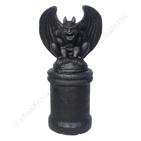 A large seated house entrance gargoyle on plinth,