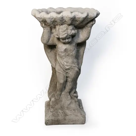 A fine concrete winged cherub and shell bird bath,