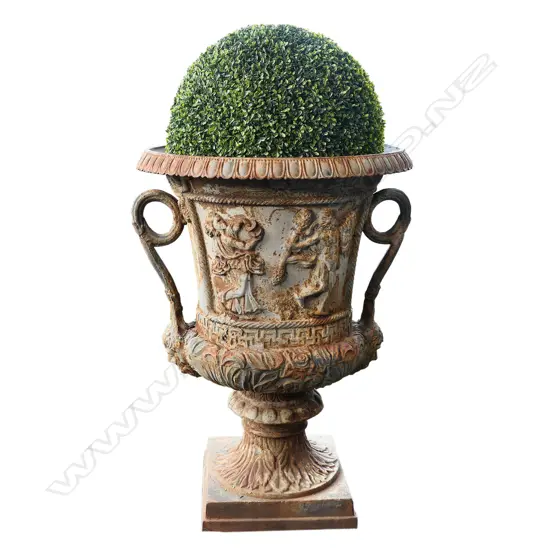 A large old cast iron garden urn,
