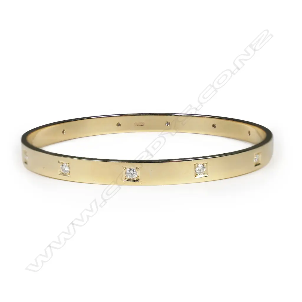 A modern 9ct yellow gold and diamond set bangle, Image 1++