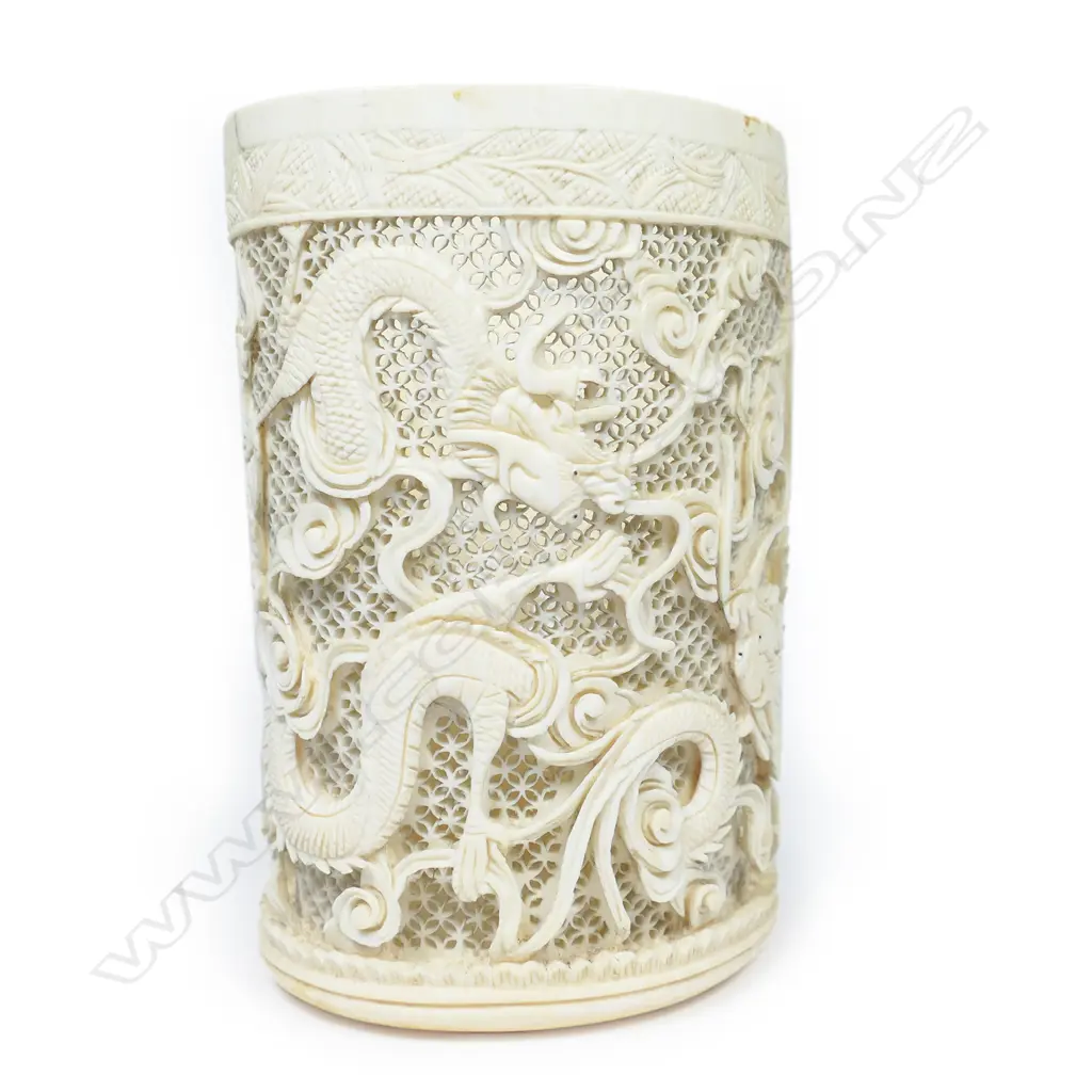 A Chinese ivory tusk section vase, carved and pierced with design of sinuous dragons, Image 1++