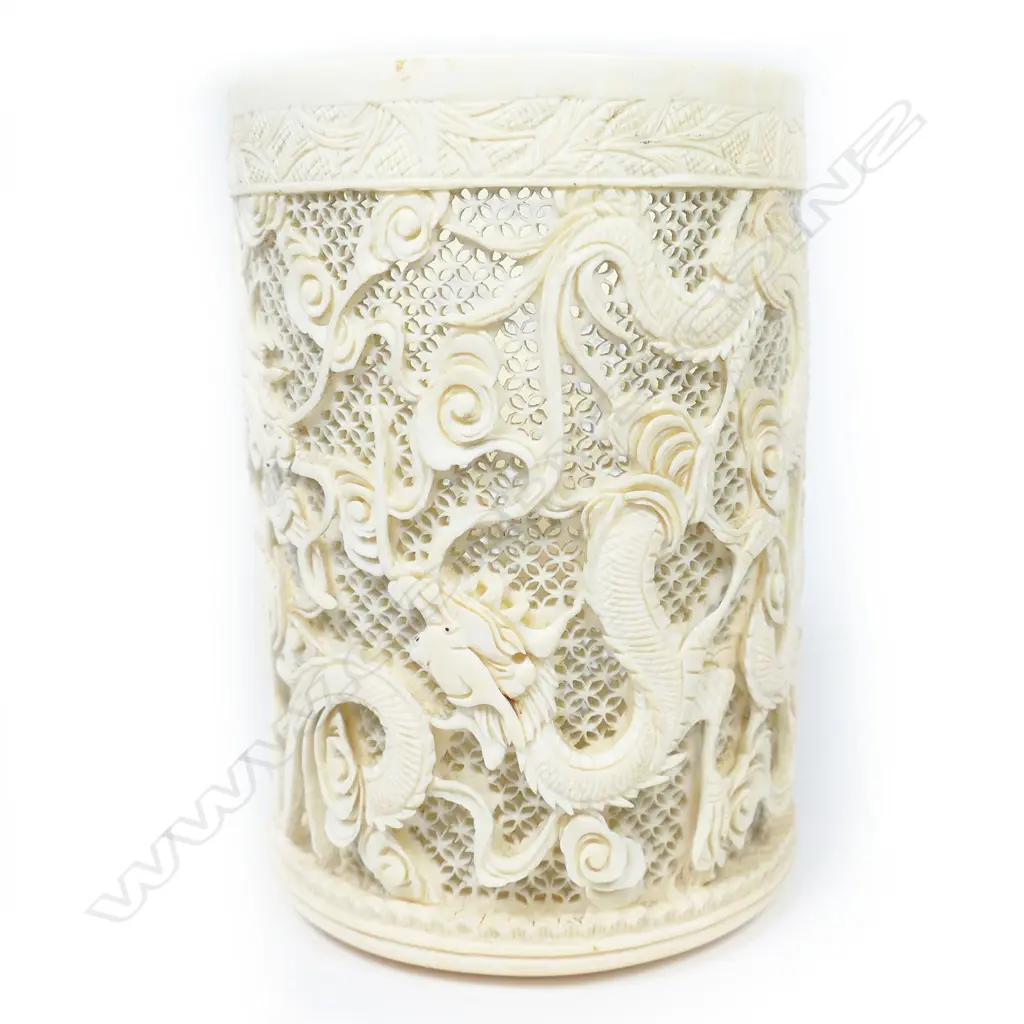 A Chinese ivory tusk section vase, carved and pierced with design of sinuous dragons, Image 1++