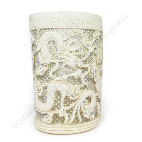 A Chinese ivory tusk section vase, carved and pierced with design of sinuous dragons,