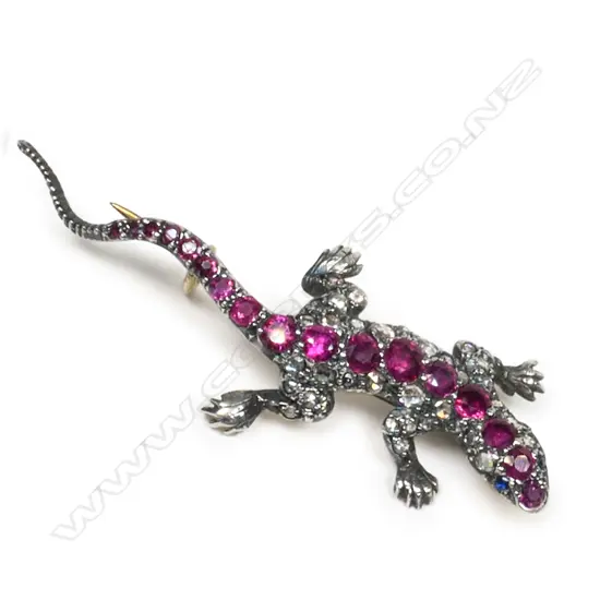 A silver gilt diamond and ruby set lizard brooch,