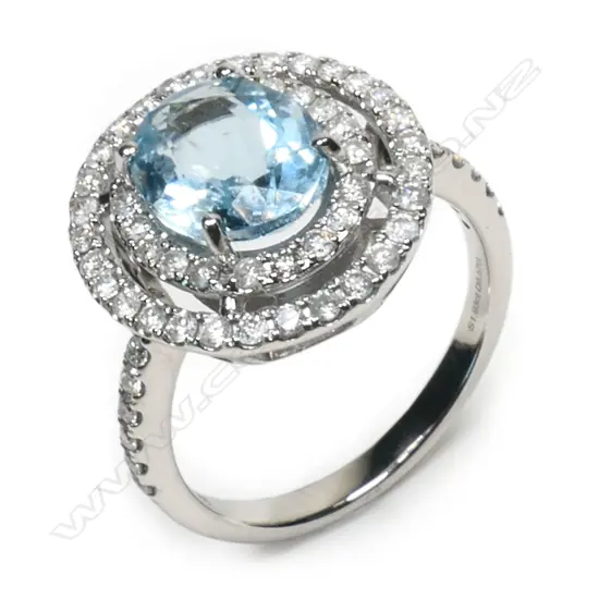 A 14ct white gold, aquamarine and diamond double halo ring,