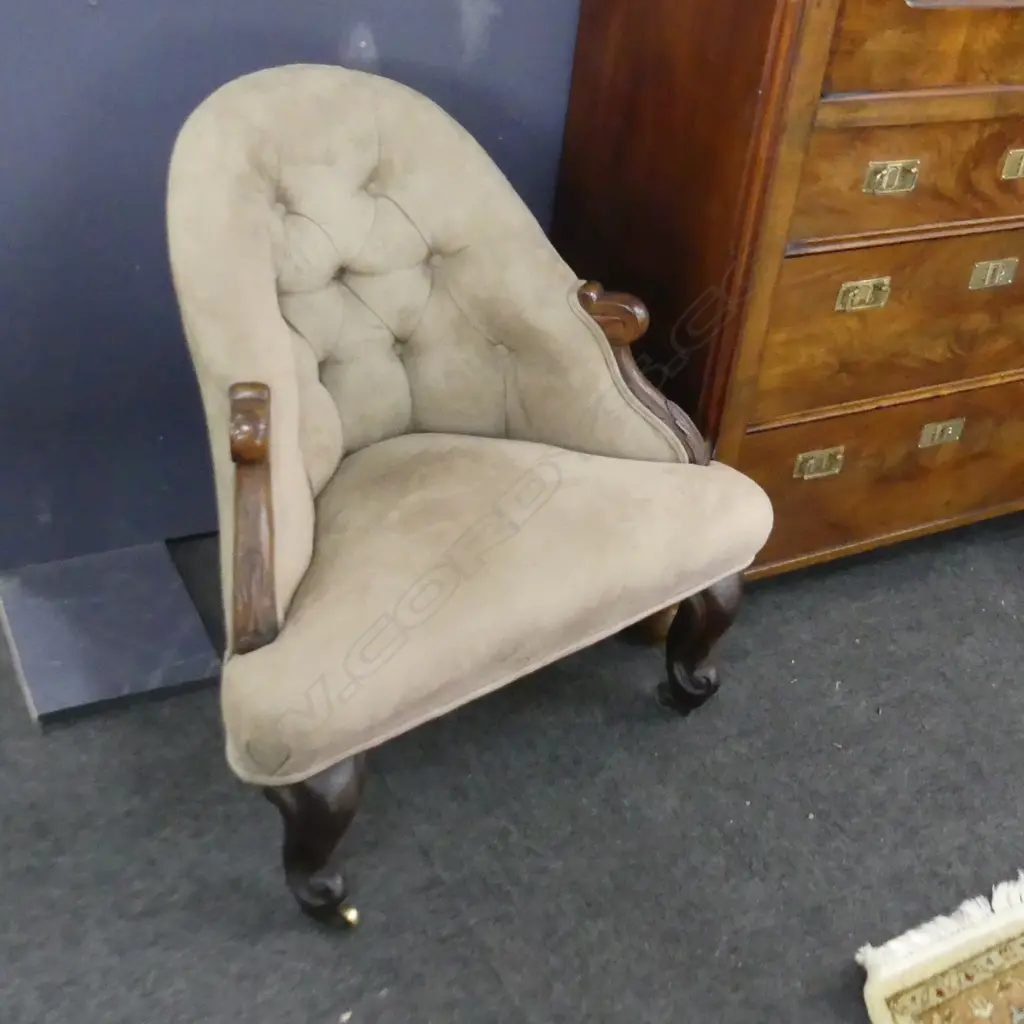 A pair of uncommon Victorian rosewood detailed corner chairs / the arched buttoned backs and sprung seats upholstered in tan suede / the carved rosewood scroll arms and feet with acanthus leaf detail. Original brass castors. 720 X 760mm. Image 1++