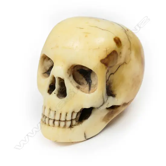 A late 19thC carved ivory skull walking cane handle,