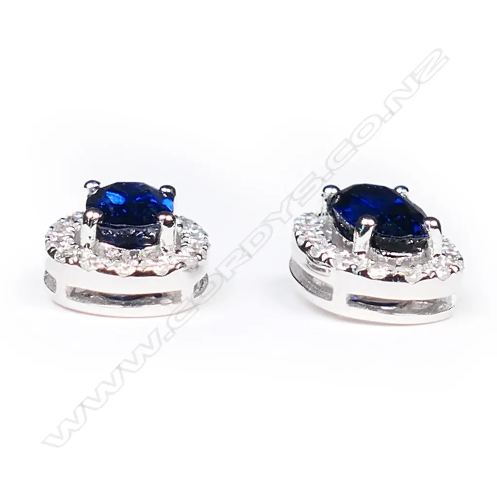 A pair of 18ct white gold sapphire and diamond cluster earrings, Image 1++