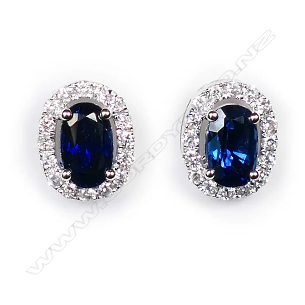 A pair of 18ct white gold sapphire and diamond cluster earrings, Image 1++