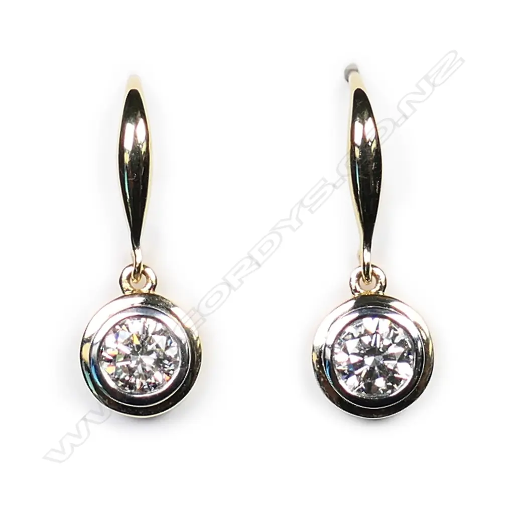 A pair of 18ct white gold and diamond solitaire earrings, Image 1++
